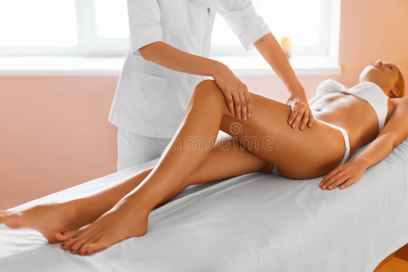 Woman legs. Body care. Girl getting leg massage treatment in spa