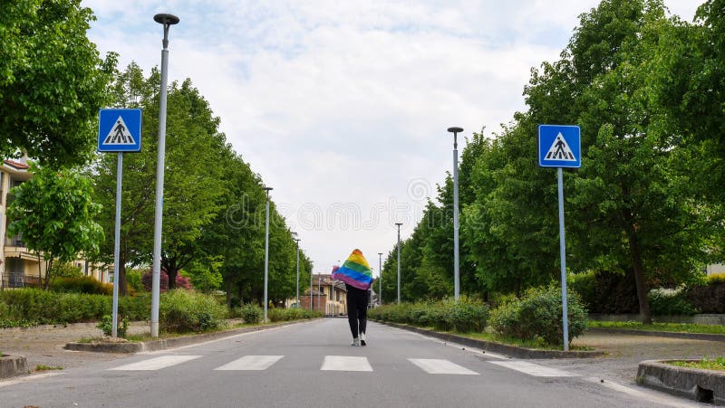 Woman lesbian n with LGBT flag on sky road royalty free stock photos