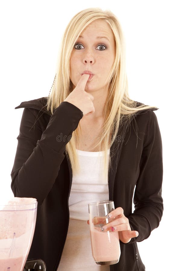 Woman licking smoothie on finger