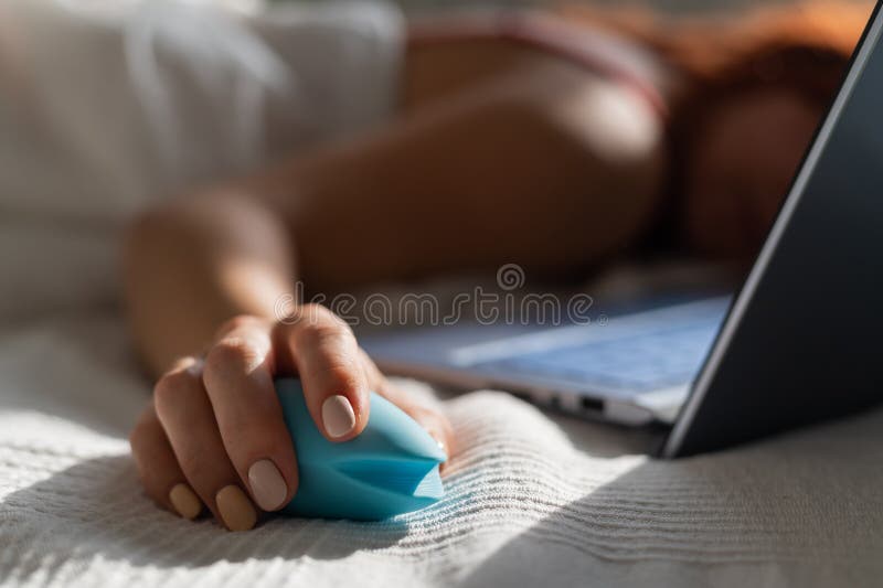Northwest All the time Premonition A Woman Lies in Bed Holding a Clitoral Vibrator and Watching on a Laptop.  the Girl Has Sex Online Stock Photo - Image of erotic, broadcasting:  207603260