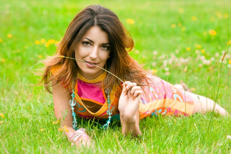 Woman lies on a grass in the field