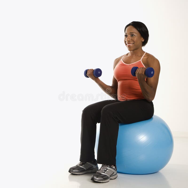 Woman Lifting Weights on Ball. Stock Photo Image of fitness, balance