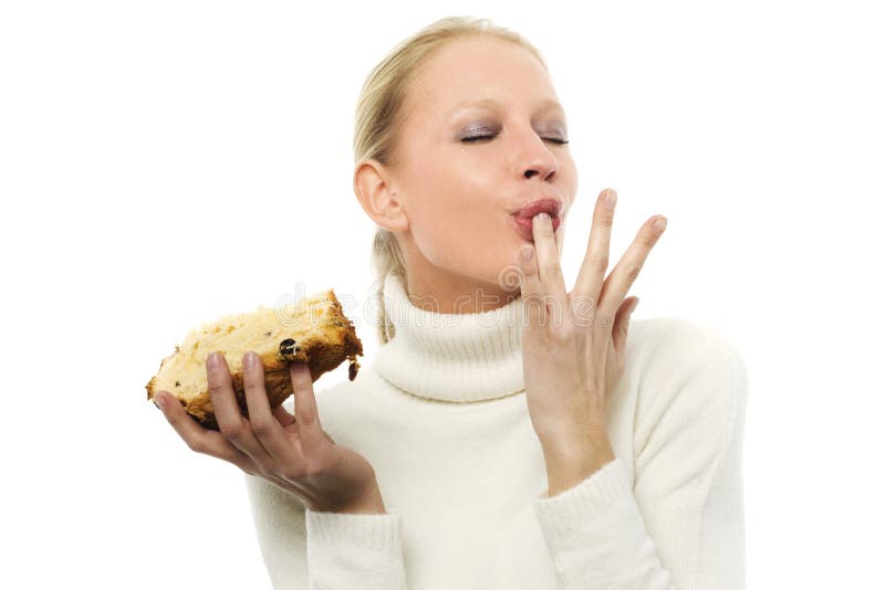 Woman liking finger with cake