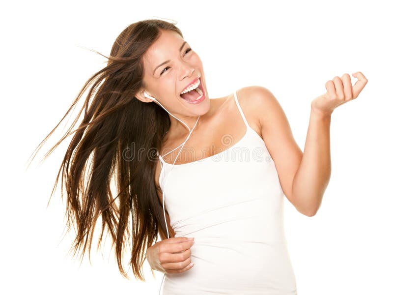 Woman dancing to music listening to mp3 player with earphones / earbuds. Energetic air guitar move by happy Asian / Caucasian dancer isolated on white background. Woman dancing to music listening to mp3 player with earphones / earbuds. Energetic air guitar move by happy Asian / Caucasian dancer isolated on white background.