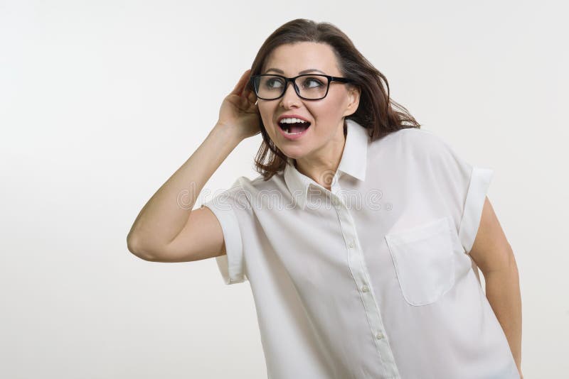 Woman listening to something holding hand near her ear. royalty free stock photos Woman listening to something holding hand near her ear. royalty free stock photos
