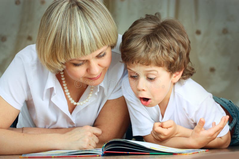 Woman and little boy reading book