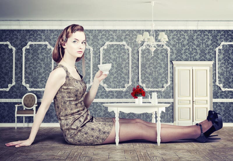 Beautiful woman in little room drink a cup of tea (concept)