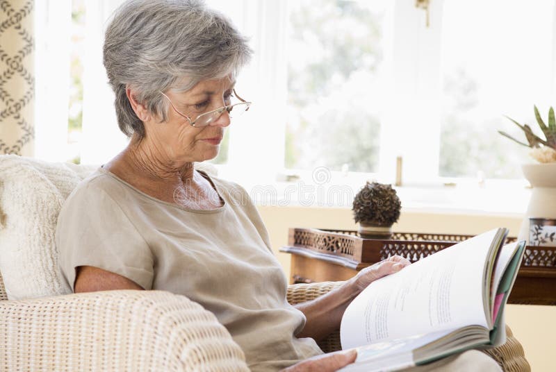 Woman in living room reading book