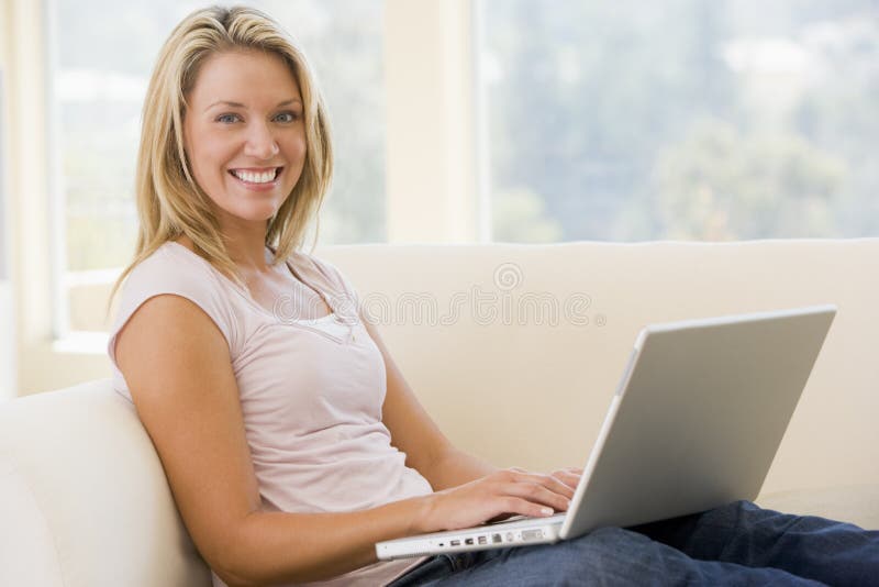 Attractive Young Woman Sitting on Couch with Laptop Computer Stock ...