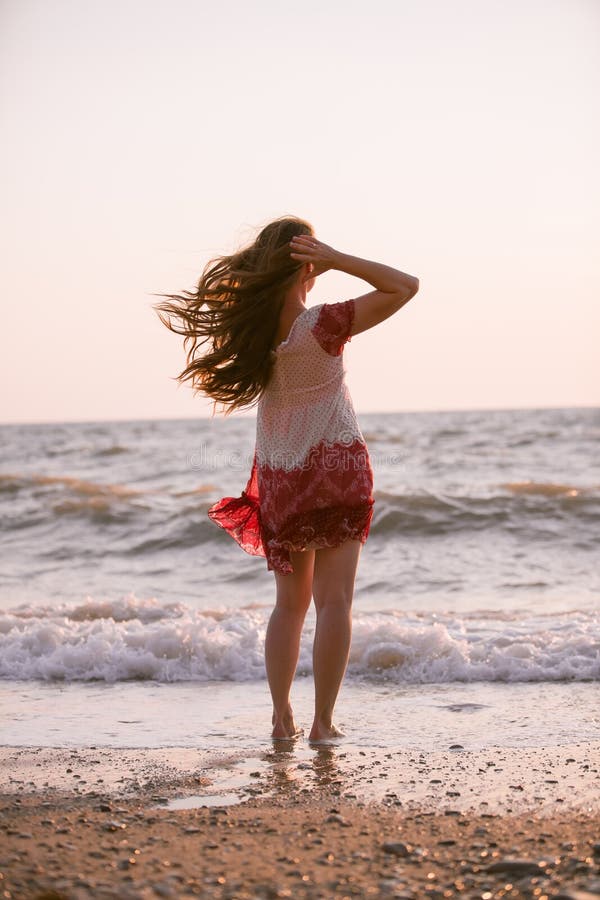 Woman with long hair on the beach stock photos