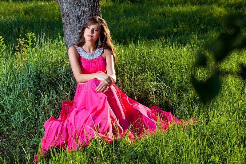 Woman in a long pink dress stock image. Image of sunlight - 25008027