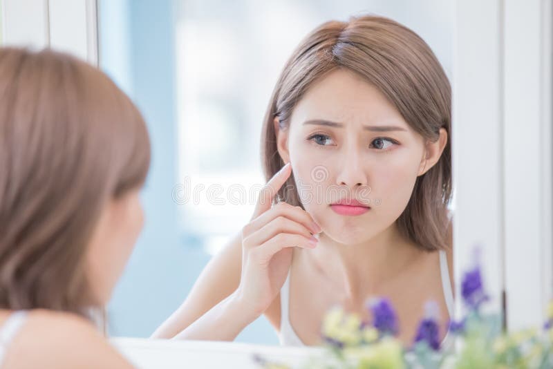 Woman look mirrior feel upset and touch her face with acne problem. Problem wrinkle stock images, royalty-free photos and pictures