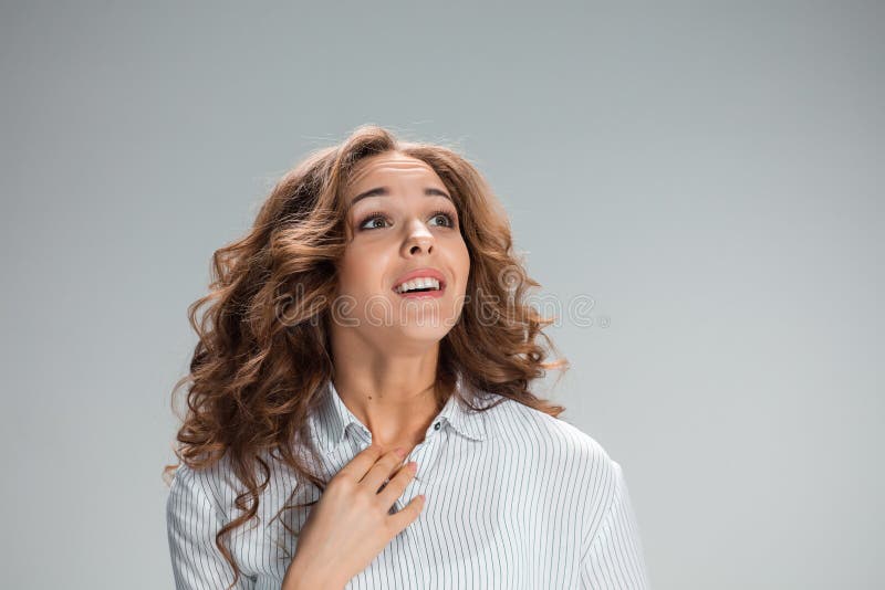 Woman is looking imploring over gray background