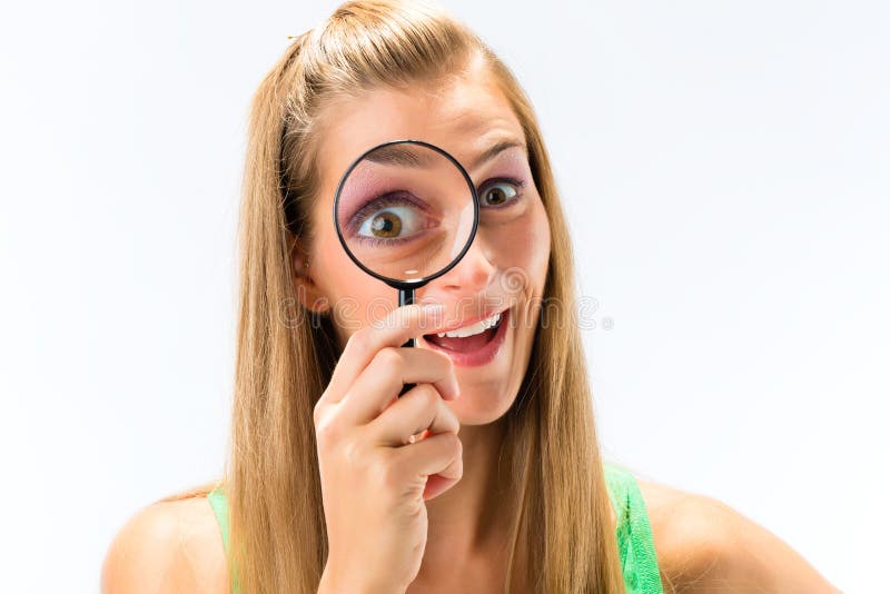 Woman looking through magnifying glass stock photo Woman looking through magnifying glass stock photo
