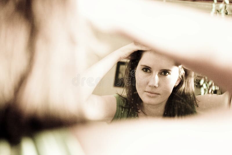 Woman looking in mirror