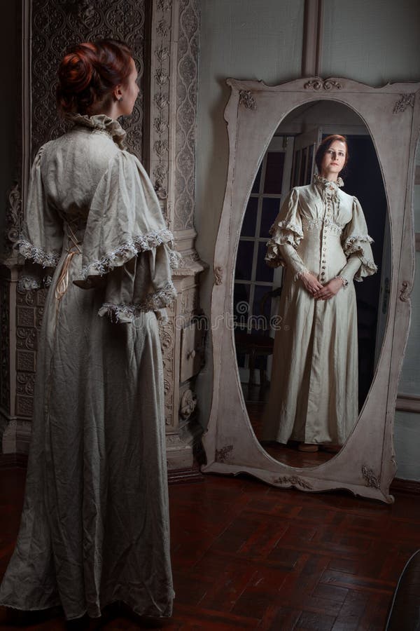 Woman looking in the mirror. stock image Woman looking in the mirror. stock image
