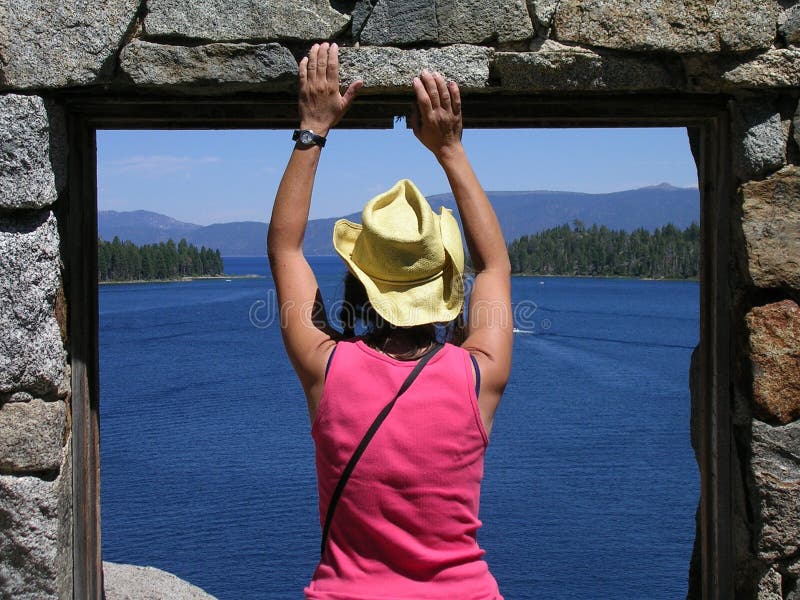 A woman takes in the view of Emerald Bay from the only island in Lake Tahoe in Californias Sierra Nevada. The Tea House is part of Emerald Bay State Park. A woman takes in the view of Emerald Bay from the only island in Lake Tahoe in Californias Sierra Nevada. The Tea House is part of Emerald Bay State Park.