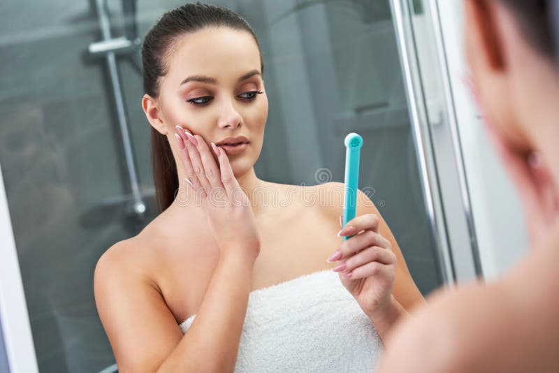 Woman Looking on Reflection in the Mirror after Shower Stock Image