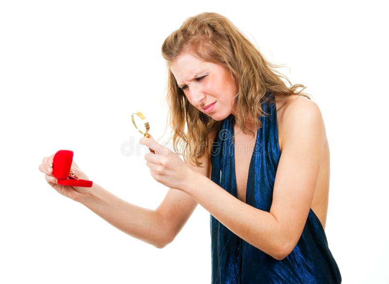 Woman looking at ring through magnifier