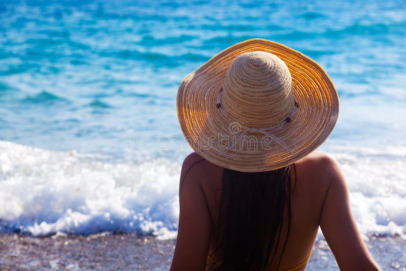 A woman is looking to the sea