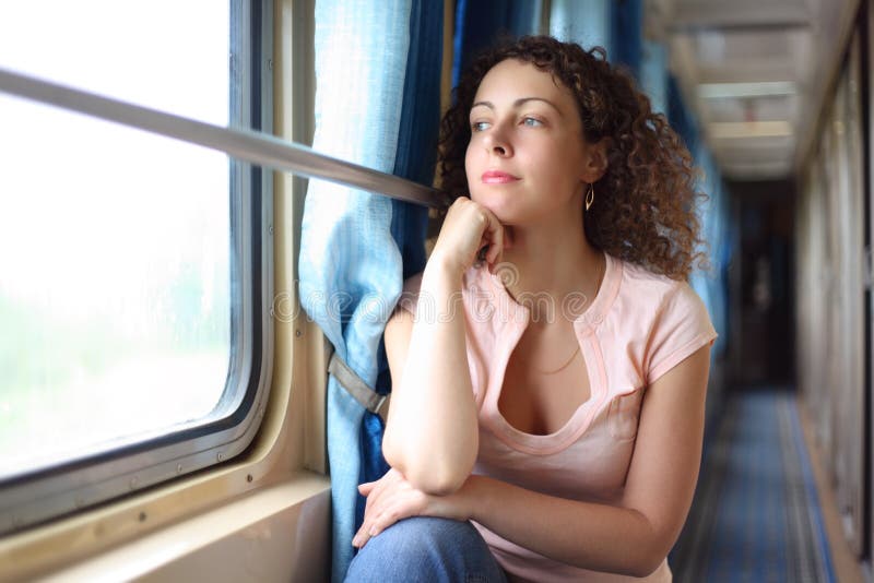 Woman looks in train`s window