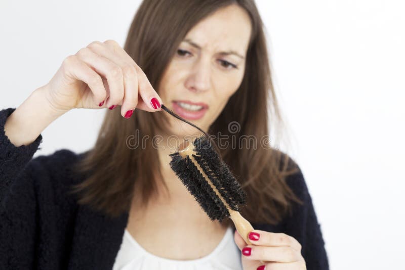 Woman taking her hair out of the brush. Woman taking her hair out of the brush