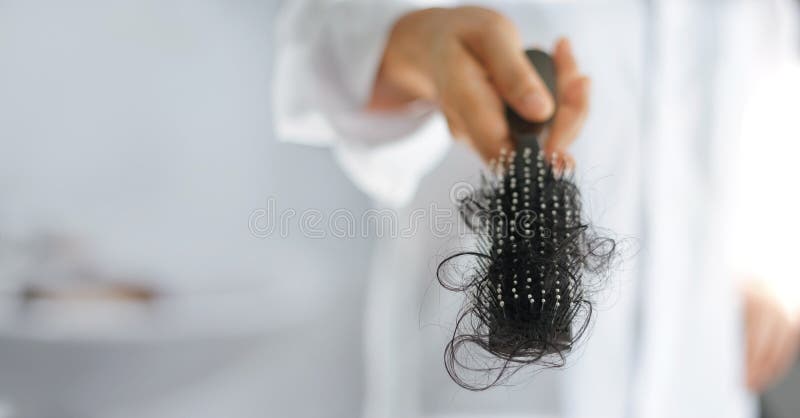 Woman losing hair on hairbrush in hand, healthcare soft focus. Woman losing hair on hairbrush in hand, healthcare soft focus