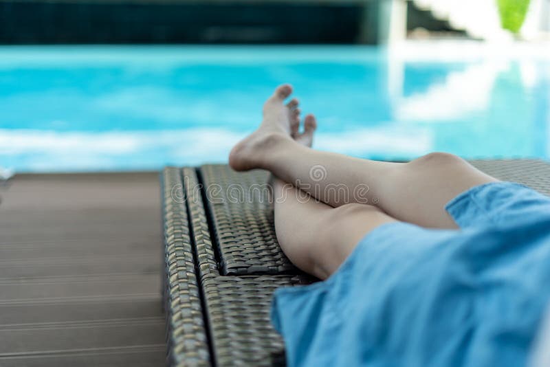 Woman Lounging And Chilling Near The Pool At An Outdoor Resort On A Relaxing Vacation Pool