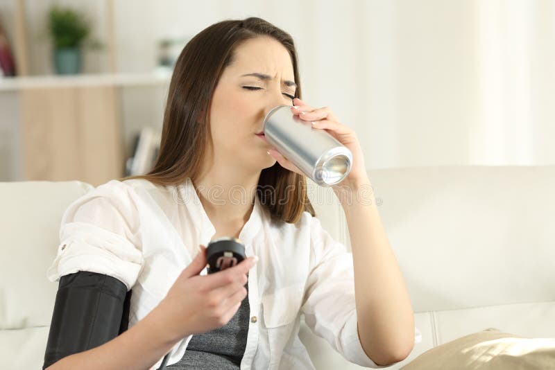 Woman with low blood pressure drinking sweet soda