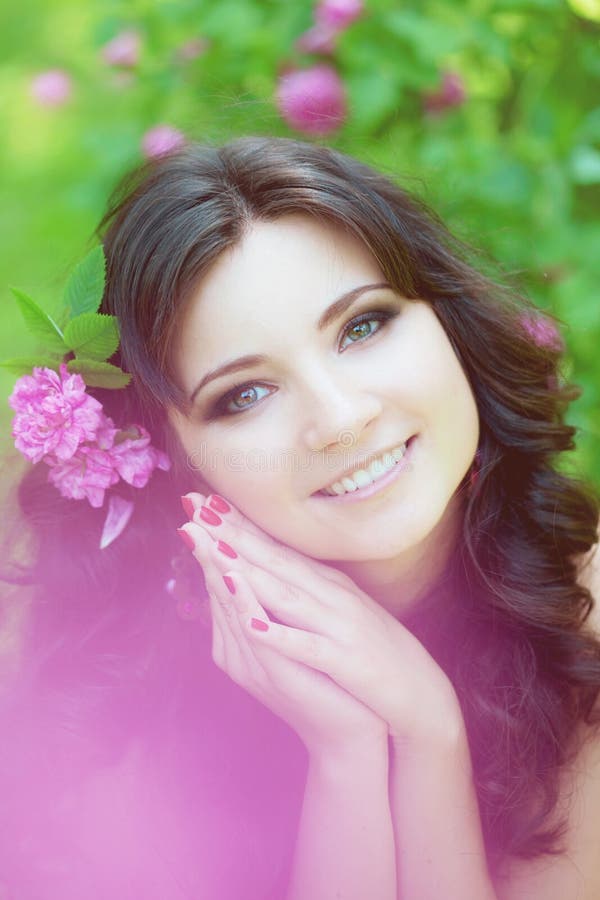 Woman in a lush garden with flowers