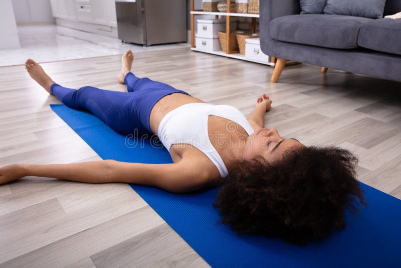 Woman Lying On Blue Yoga Mat royalty free stock images Woman Lying On Blue Yoga Mat royalty free stock images