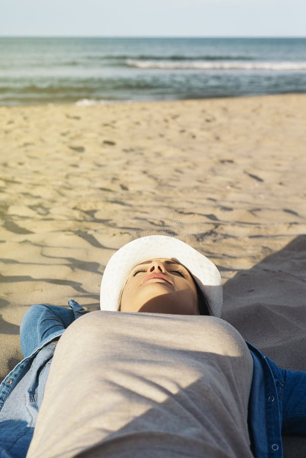 Woman Lying Relaxing on the Beach. Stock Photo - Image of lying ...