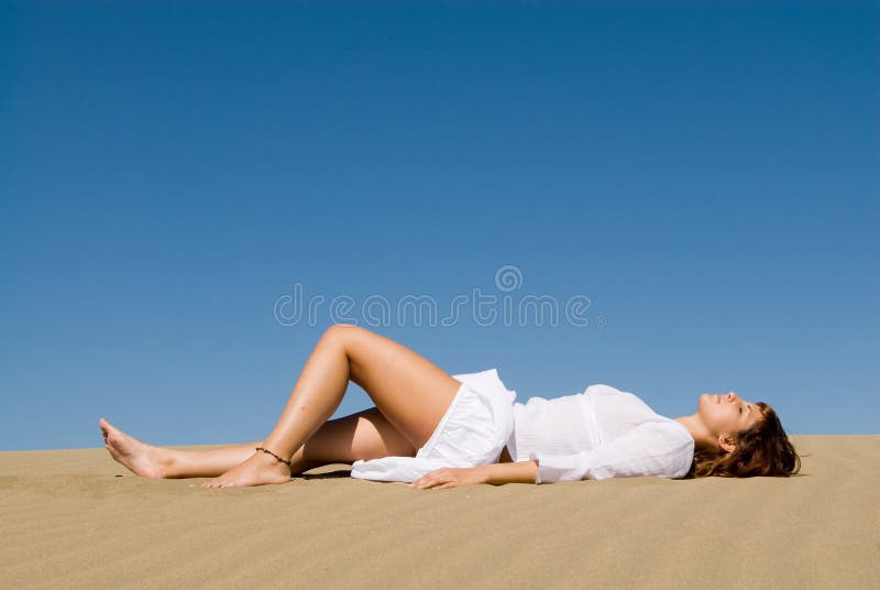 Woman lying in the sand