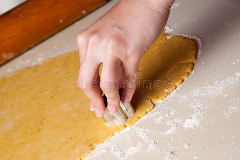 A woman maikng cookies in kitchen
