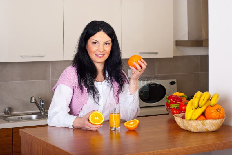 Woman make fresh orange juice stock photography