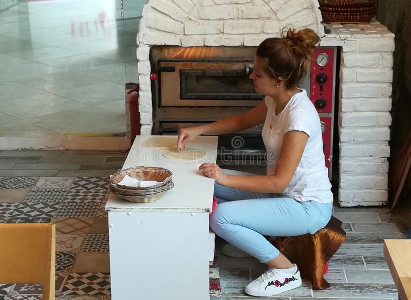 Woman makes pita bread