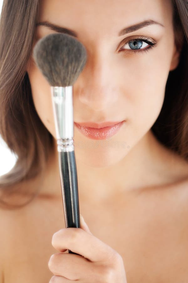 Woman with makeup brush