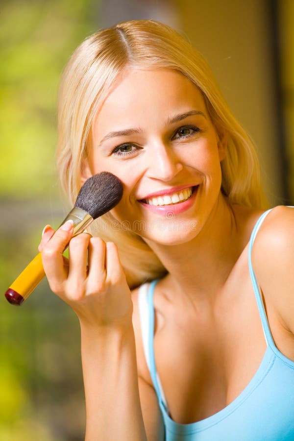 Woman with makeup brush stock photos