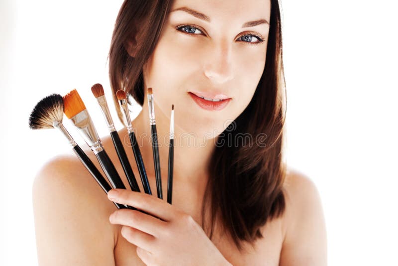 Woman with makeup brushes