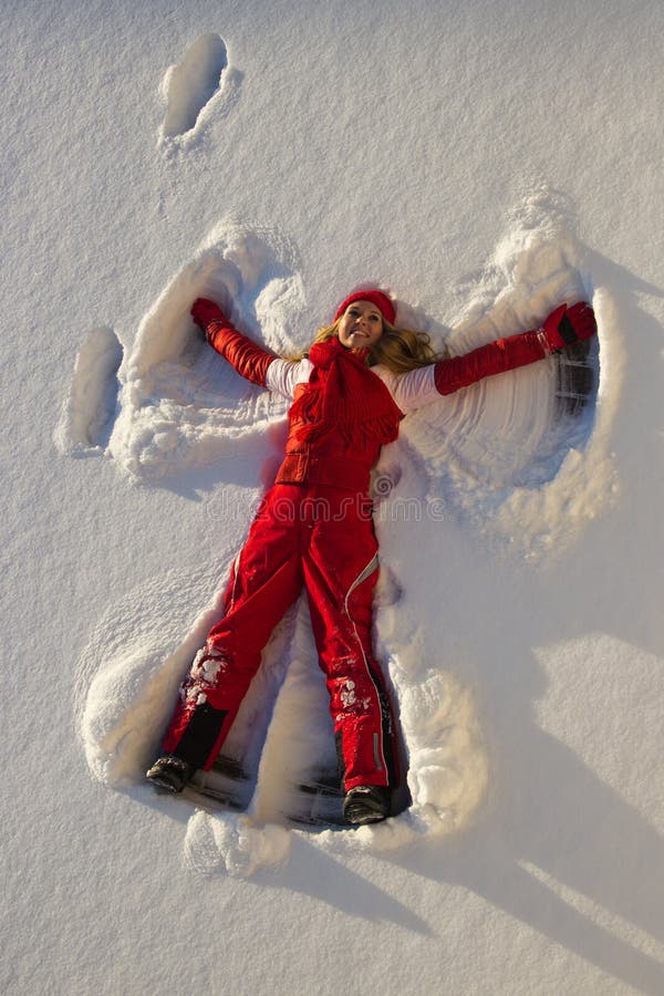 Woman making an angel on snow