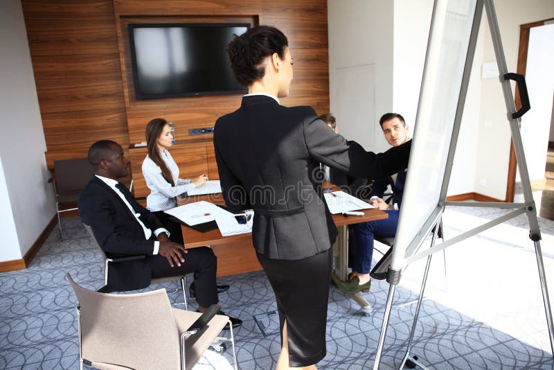 Woman making business presentation to a group royalty free stock photo Woman making business presentation to a group royalty free stock photo
