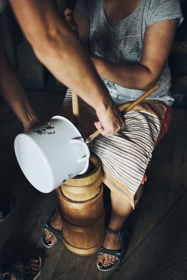 Woman Making Butter with Butter Churn. Old Traditional Method Making of