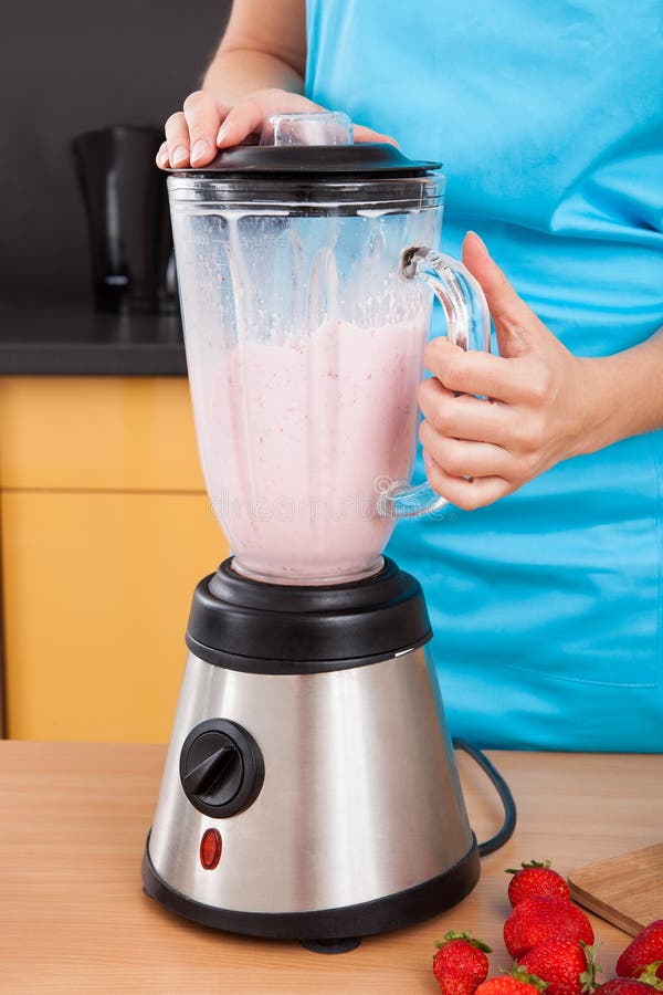 Woman Making Strawberry Milkshake