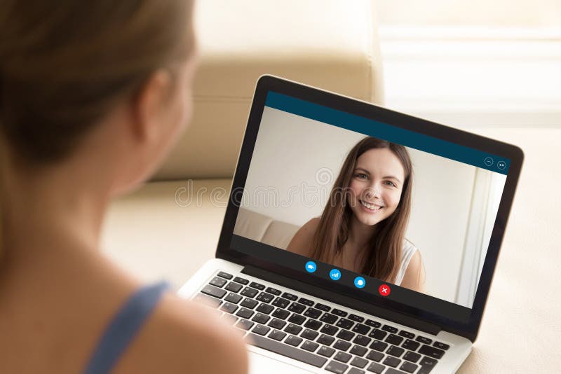 Woman making video call to female friend on laptop.