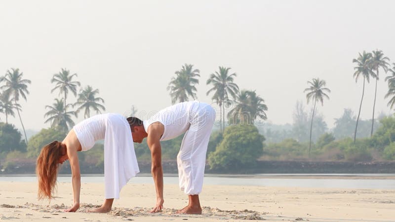 Woman and man doing yoga