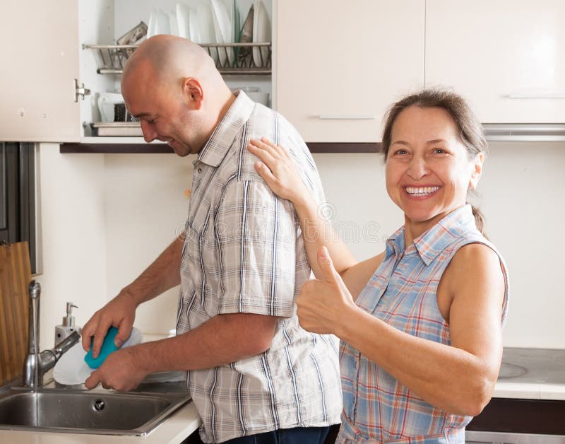 Mature Man Washing Dishes Stock Photo