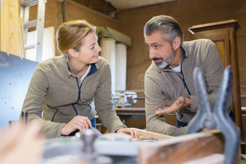 Woman and man wooden working royalty free stock photography Woman and man wooden working royalty free stock photography