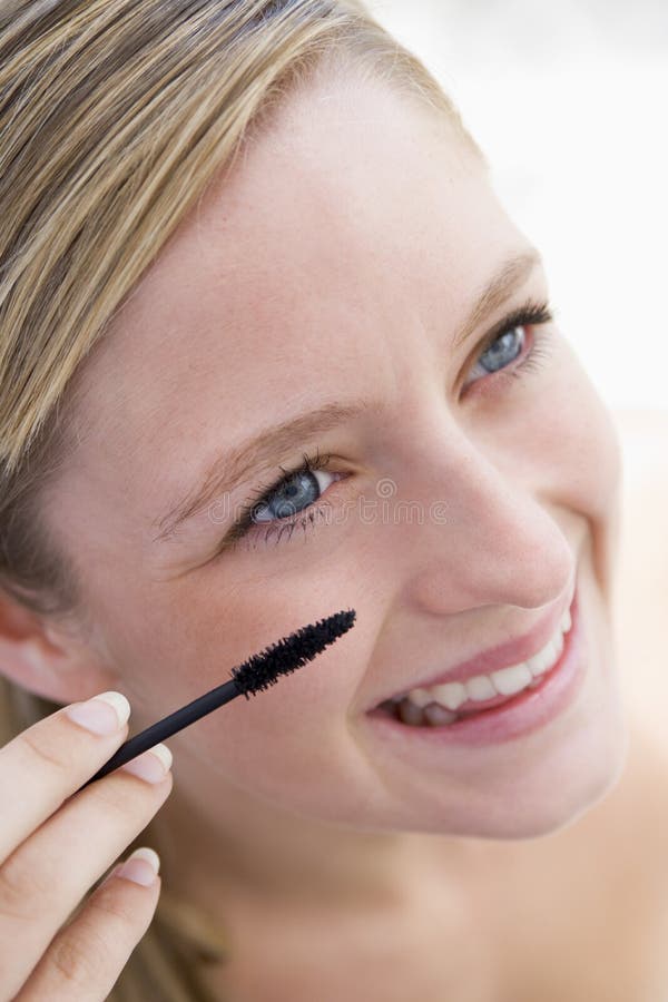 Woman with mascara wand stock photography