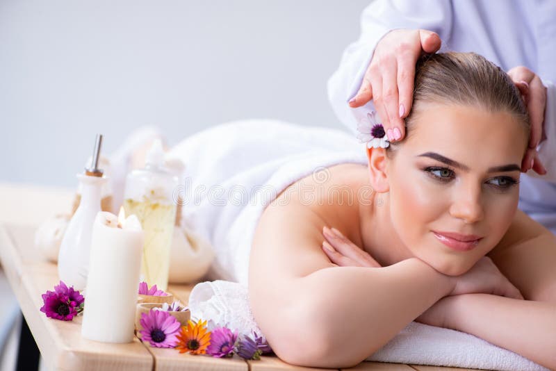 The woman during massage session in spa. Lying, cute.