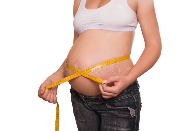Woman measures a stomach by tape
